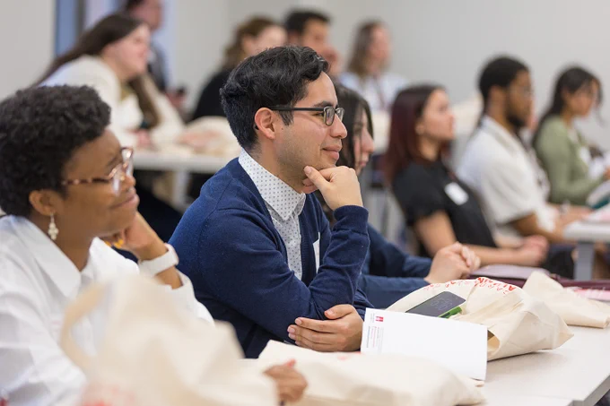 A photo of an alum listening to a presentation at the 2026 Cardinal First Alumni Academy.