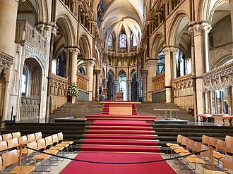 Columns arches in the walls line the long stairs leading to the alter in Canterbury Cathedral.