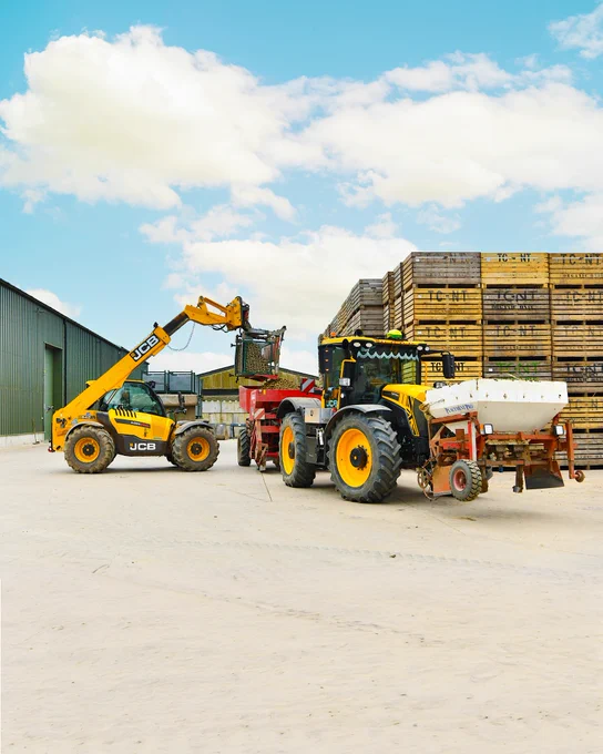 A JCB telehandler and JCB tractor working on a farm