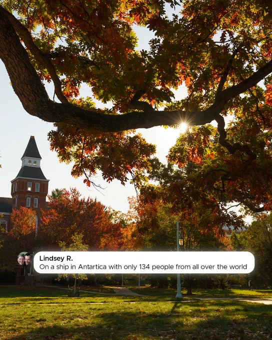 Sunlit autumn scene with trees in green and orange hues, framing a building with a tall tower. Text overlay says, \"Lindsey R. On a ship in Antarctica with only 134 people from all over the world.\"