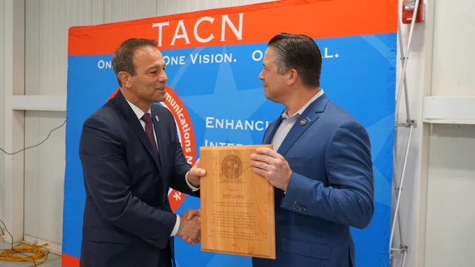 Montgomery County Mayor Wes Golden presents TDOSHS Deputy Commissioner & Chief of Staff Les Dolente with a plaque celebrating the partnership.