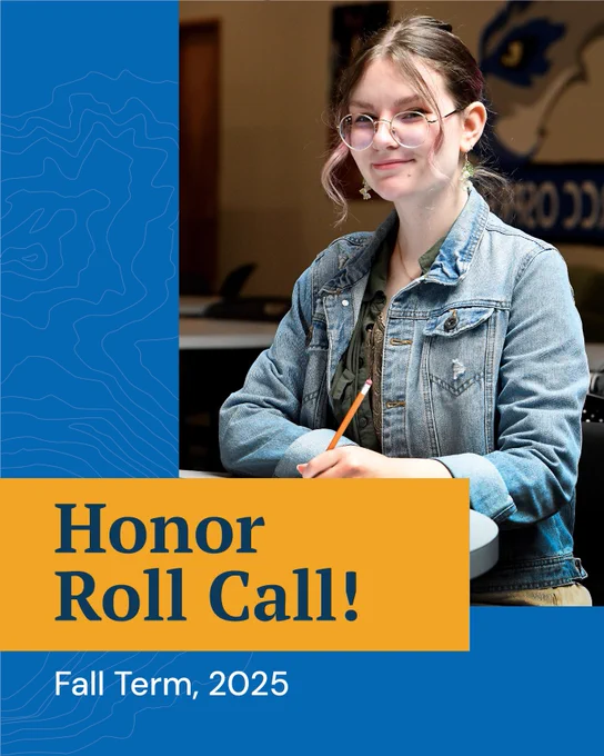 A young female student with glasses and a jeans jacket sits with a pen and paper at a desk, smiling at the camera. copy reads, honor roll call! Fall term, 2025. This post celebrates honor roll students.