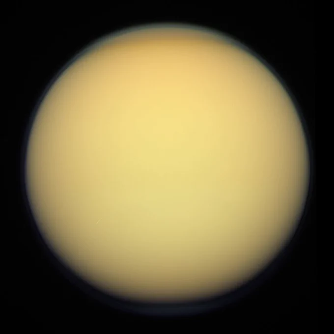 Titan, imaged by the Cassini orbiter, December 2011. A thick shroud of organic haze permanently obscures Titan's surface from viewing in visible light.