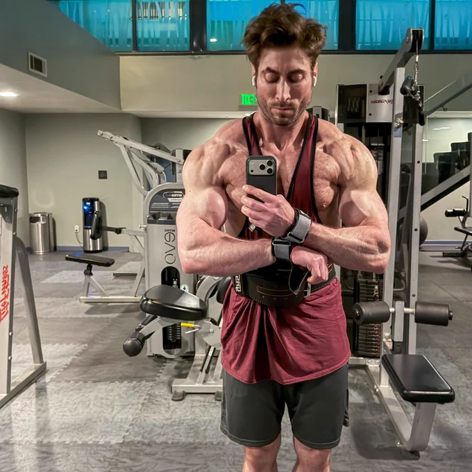 A professional bodybuilder and fitness model working out in the gym.