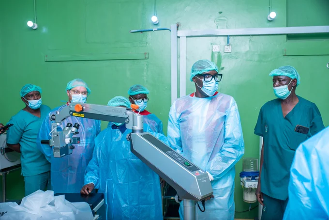 A joint CBM and partner delegation during a showcase of the state-of-the-art eye care equipment provided by CBM and COCIN Community Development Programme Molai.