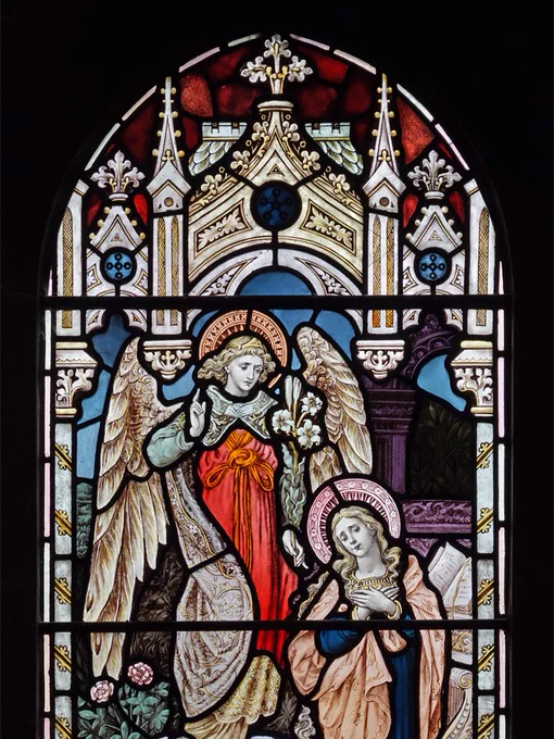 Stained glass in the south aisle of St. Peter's church, March, Cambridgeshire. This depicts the Annunciation of the Archangel Gabriel to the Virgin Mary, one of a sequence depicting the story of Jesus' birth.