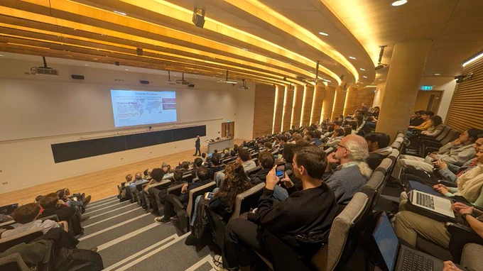Audience view of Mark Thomson speaking in the Ray Dolby Auditorium