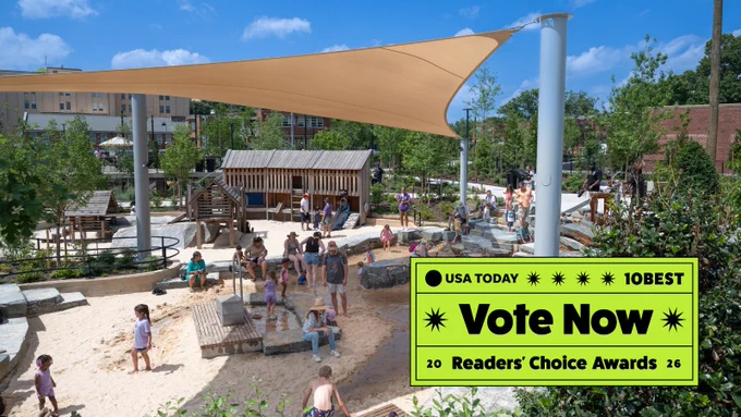 Children playing in a sunny outdoor sand pit with wooden structures and a large beige shade sail overhead. Bright green overlay graphic with the text USA Today 10Best, Vote Now, 2026 Readers' Choice Awards.