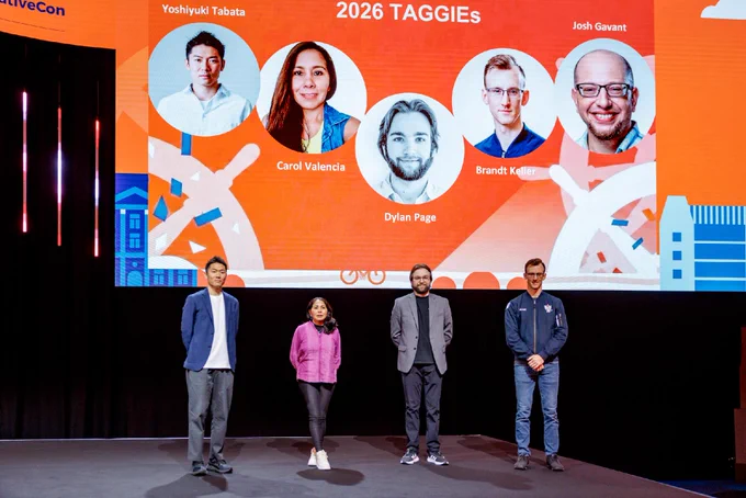 Four of the five TAGGIE winners in person under their keynote slide on stage