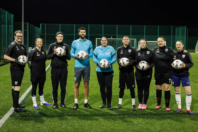 Proud Baggies squad in team trainingwear holding the EFL Rainbow Balls.