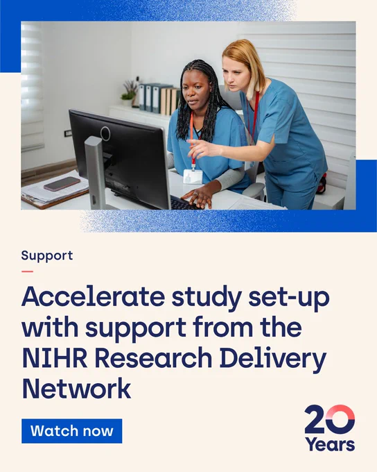 Two healthcare professionals in scrubs work at a computer. One sits, focused on the screen, while the other points at it, giving instructions. The setting is an office with a window and files on a shelf. The text below reads: "Support. Accelerate study set-up with support from the NIHR Research Delivery Network. Watch now." There's a "20 Years" logo in the bottom right corner.