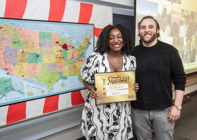 Woman and man standing in front of a map of the US
