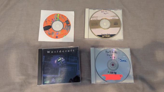 4 CDs, from top to bottom and left to right: Half-Life Preliminary Findings, Half-Life: Day One (9/19/98 - Gold 1 'Banshee OEM'), Worldcraft, Half-Life Gold v1.0 (11-08-98)