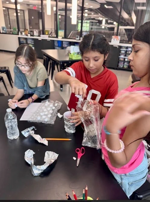The girls insulating their plastic cup.