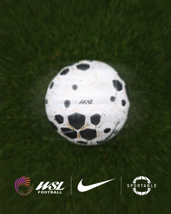 A top-down, slightly blurred action shot of a white and black Nike flight football resting on a lush green grass pitch. The ball features the Barclays Women’s Super League (WSL) branding. At the bottom of the frame, a clean graphic strip displays the logos for WSL Football, the Nike swoosh, and Sportable, indicating a technical partnership.