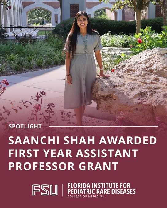 A woman stands outdoors in a courtyard, leaning against a large rock, above a maroon banner announcing that Saanchi Shah has been awarded a First Year Assistant Professor Grant from the FSU Florida Institute for Pediatric Rare Diseases.