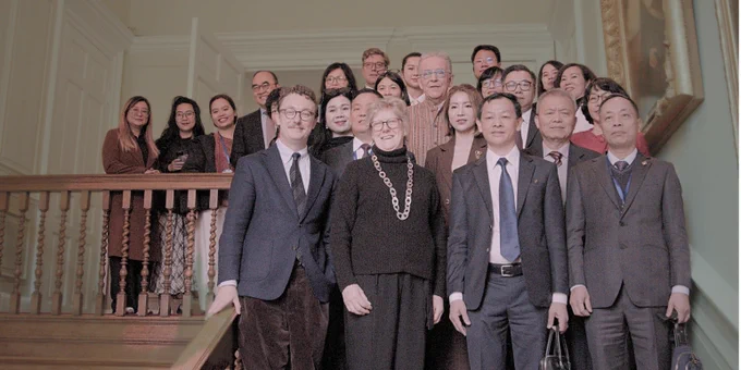 Delegation representatives from Vietnam’s Ministry of Health, and university medical faculty from Hanoi and Ho Chi Minh, gathered with Trinity's Master Dame Sally Davies on a staircase during a recent visit to Trinity College Cambridge.