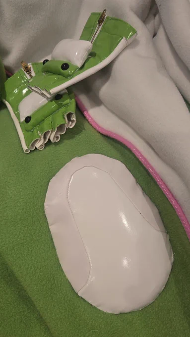 Close up of some knee pads on a onesie and Nessie gloves