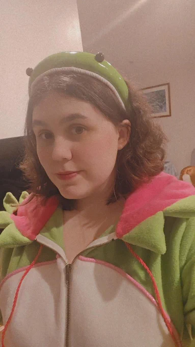 A selfie of chloe trying on her onesie and headband
