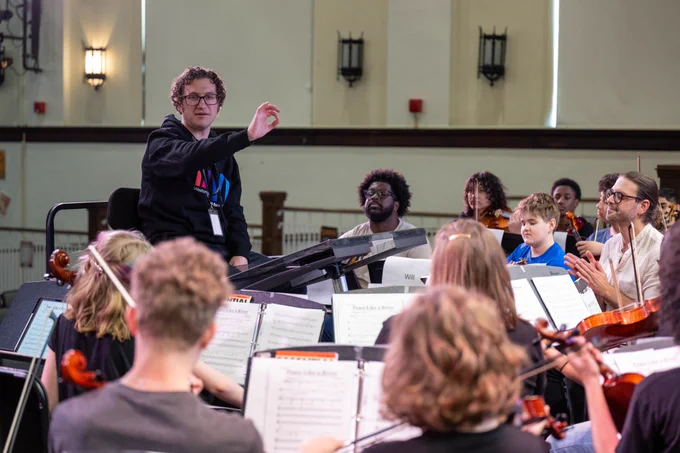 Students play instruments.