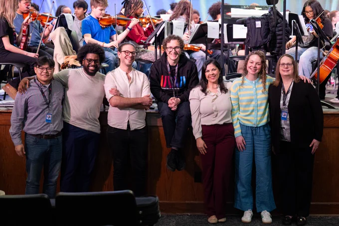 Adults pose for a picture and smile. 