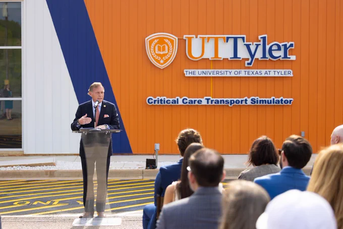 Chancellor John Zerwas standing in front of new Helicopter Critical Care Transport Simulation building.