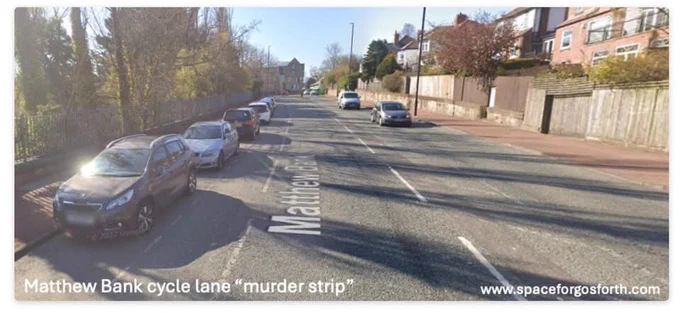 Picture of Matthew Bank “murder strip” cycle lane between parked cars and a busy highway.