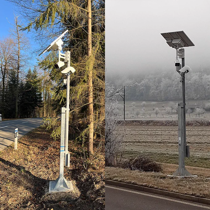 Split photo showing two DL-CWS2 | High-Precision Winter Road Maintenance Sensor with Radiation Shield for LoRaWAN at different roadside locations. The left image shows a sensor on a sunny spring day with blue sky, green conifers, and a dry road. The right image shows another unit surrounded by dense frost — trees, fields, and the landscape covered in ice under grey, foggy skies. Both sensors are battery-powered and weatherproof, monitoring road conditions year-round regardless of season.