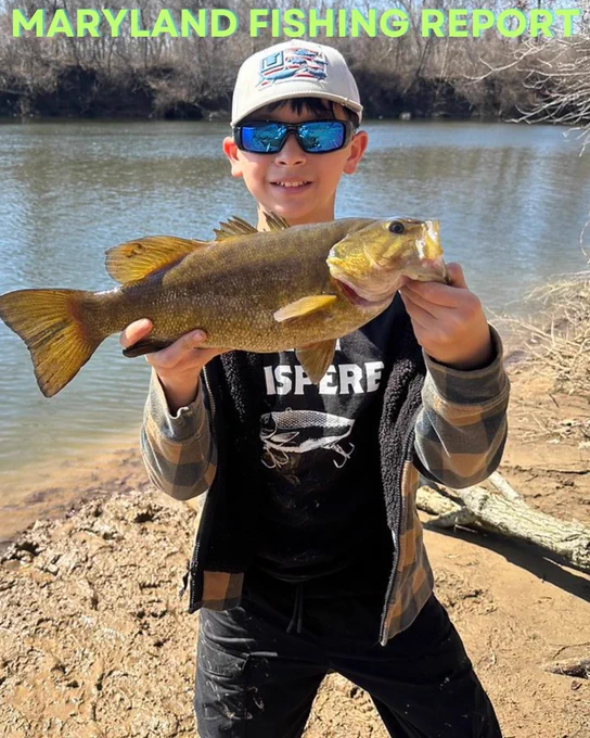 youth angler holding a fish