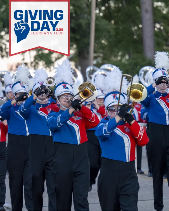 Louisiana Tech band members march with trumpets. The 2026 Giving Day logo is in the top left corner in a white banner.