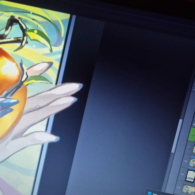 The image shows one image being edited, with part of a golden sphere being held by some slender female fingers, and some leaves.