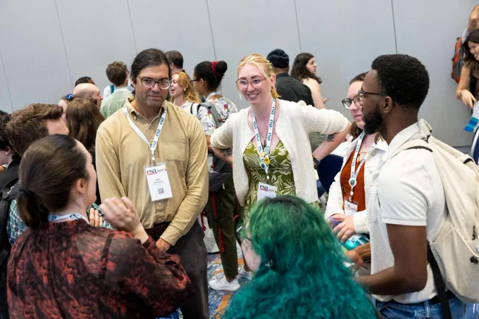 A diverse group of aquatic scientists having a fun conversation together at the 2025 ESA Annual Meeting
