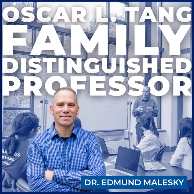 Edmund Malesky standing and talking to students who are sitting at tables with laptops. Text on image says: Oscar L. Tang Family Distinguished Professor. 