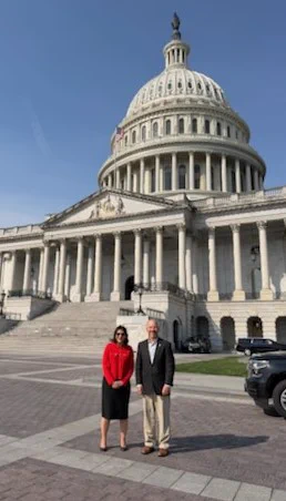 Two individuals standing outside of the US Capitol
