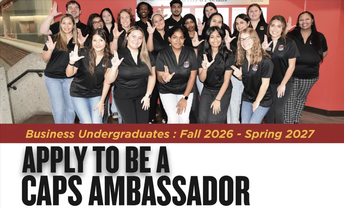 A group of people wearing black shirts stand together, smiling and forming hand signs. They are positioned in front of a wall with a red background featuring the Sam Houston State University logo. A banner reads, "Business Undergraduates: Fall 2026 - Spring 2027," and below, in bold letters, "Apply to be a CAPS Ambassador.