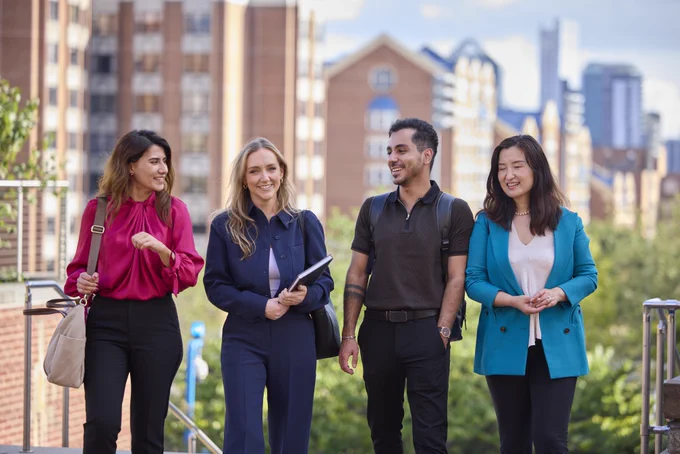 Georgetown students walking in front of the Hariri building. 