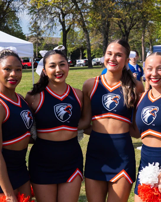 Four UTTyler cheerleaders pose for a photo at pep rally kick off
