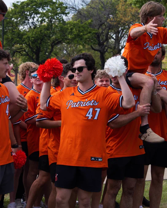 UTTyler baseball player 47 holding two pom pots during pep rally kick off