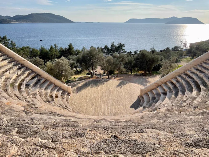 Explore the ancient ruins of Antiphellus Theatre overlooking the picturesque coast of Kaş, Türkiye.