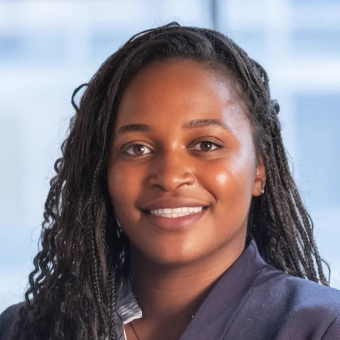 A headshot photo of an alum. They are looking forward and smiling.