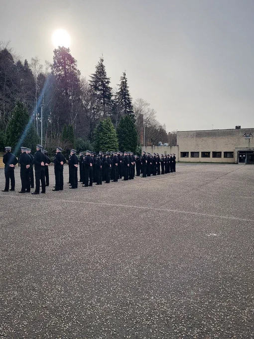 Police officers standing on the parade square during a drill lesson.