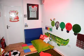 A room with lots of colourful pillows and sensory objects on the walls.