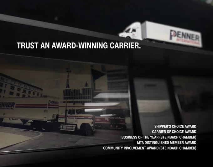 The image shows a dark shelf displaying framed historical photographs of Penner International transport trucks in urban settings. On the top shelf sits a detailed miniature Penner International semi‑truck model with the company’s logo clearly visible. At the top left of the image, large white text reads “TRUST AN AWARD‑WINNING CARRIER.” In the lower right corner, smaller white text lists several awards, including Shipper’s Choice Award, Carrier of Choice Award, Business of the Year from the Steinbach Chamber, MTA Distinguished Member Award, and Community Involvement Award from the Steinbach Chamber.