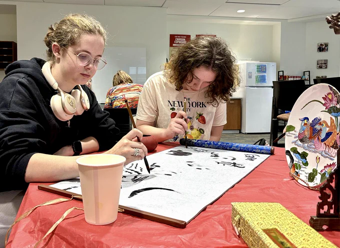 people writing calligraphy