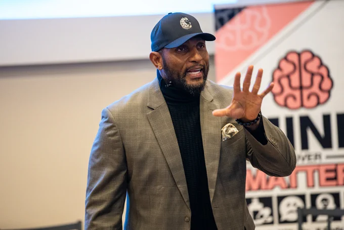 Ray Lewis speaking with hand raised during a presentation at the Mind Over Matters event