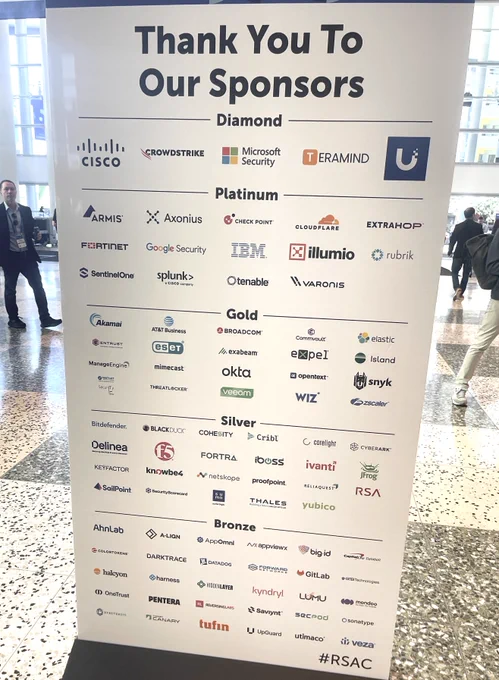 A sponsorship board displays logos of various companies sponsoring an event. The logos are categorized into tiers: Diamond, Platinum, Gold, Silver, and Bronze. Notable entities include Cisco, Microsoft Security, and CrowdStrike.