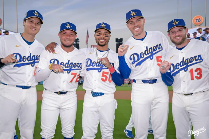 A photo of Shohei Ohtani, Miguel Rojas, Mookie Betts, Freddie Freeman and Max Muncy holding their World Series rings.