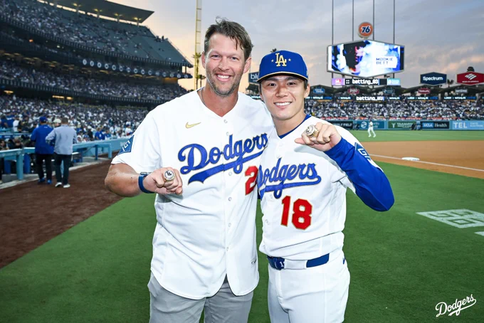 A photo of Clayton Kershaw and Yoshinobu Yamamoto holding up their World Series rings.
