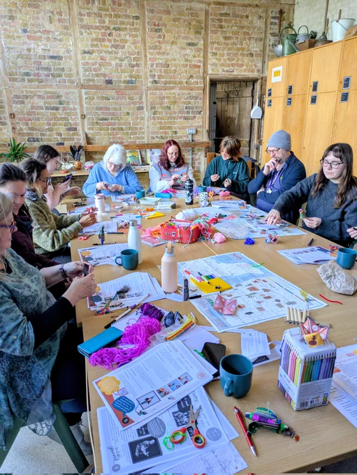 Group of adultd sound around a table cradting