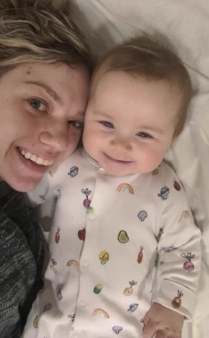 Charlotte and baby Murphy cuddling and smiling.